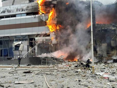 In this photo provided by the Ukrainian Emergency Service, firefighters work on the site of a building damaged after a Russian attack in Kyiv, Ukraine, Friday, December 29, 2023. 