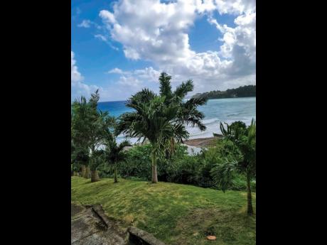 The palm-tree lined garden overlooks the awesome sea and coastline vistas.