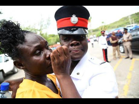 File photo shows woman constable Donique Anderson and her mother Gem Donald (left) sharing an emotional moment at the passing out parade and awards ceremony at the National Police College of Jamaica in Twickenham Park, Spanish Town, St Catherine.
