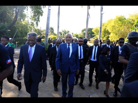 FILE – Haitian Prime Minister Ariel Henry (centre) leaves at the end of a ceremony marking the anniversary of the Battle of Vertieres, the last major battle of Haitian independence from France, at the National Pantheon Museum in Port-au-Prince, Haiti, No