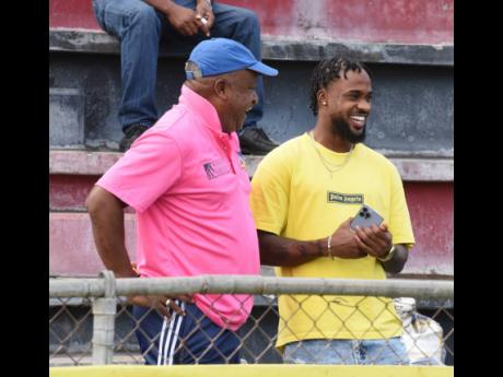 Lenworth Hyde (left), coach of Dunbeholden, and Junior Flemmings,  former Tivoli Gardens player and Reggae Boy, sharing a moment just before the start of the Wray and Nephew Jamaica Premier League football match between Tivoli Gardens and Lime Hall at the 