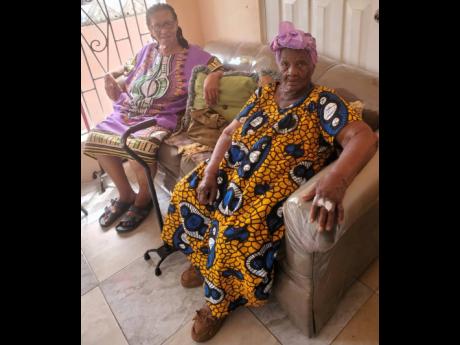 Ninety-five-year-old Agatha Vanzeita Chambers-Neil (right) with her friend and neighbour Icyline James.