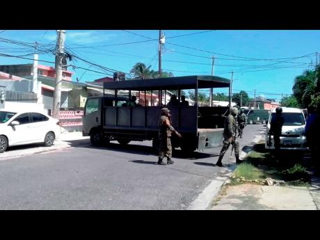 Credit: File Detectives of the Counter-Terrorism and Organised Crime Unit and members of the Jamaica Defence Force carry out an operation in St James.
