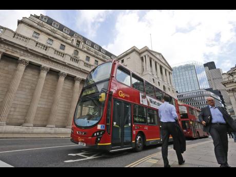 A London bus passes by the Bank of England in London on August 4, 2016.