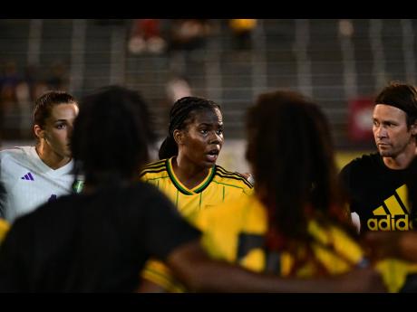 
Reggae Girlz Captain Khadija Shaw (centre) speaks during a team huddle following the team’s Olympic qualification game against Canada at the National Stadium in St Andrew, Jamaica on September 22, 2023. 