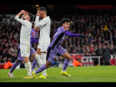 Liverpool's Luis Diaz (right) celebrates after his side's first goal during the English FA Cup  match between Arsenal and Liverpool at Emirates stadium in London yesterday.  The opening goal was an own goal by Arsenal's Jakub Kiwior.
