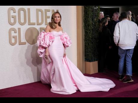 Fresh off her Jamaican-infused ‘Can’t Get Enough’ remix, Jennifer Lopez walks the red carpet in a stunning baby pink, strapless mermaid dress.