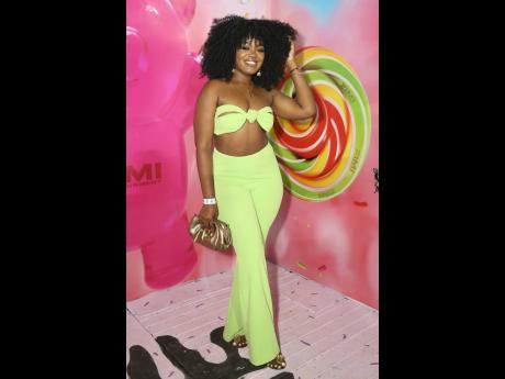 Bringing a radiant fusion of vibrant style and natural elegance, Drezel Simmonds completes her outfit with gold accents.