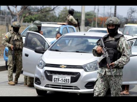 Soldiers check for weapons at a check-point on a north-bound highway in Guayaquil, Ecuador.