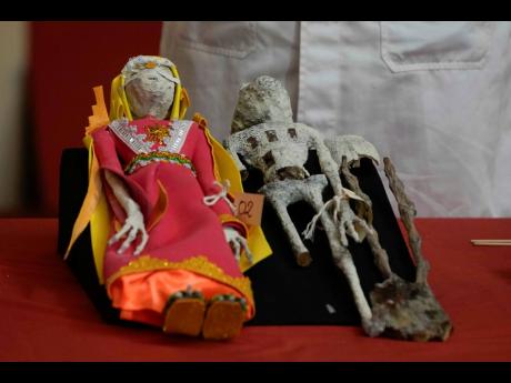 Dolls that were seized by authorities are displayed during a press conference to explain what they are made of at the Archeology Museum in Lima, Peru, Friday, January 12.