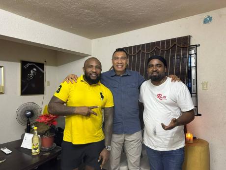 Credit: Gareth Davis Sr From left: Aubyn Hall, Prime Minister Andrew Holness, and Telief ‘Peter’ Hall share a special moment at Roots 21 fine-dining restaurant in Port Antonio, Portland.