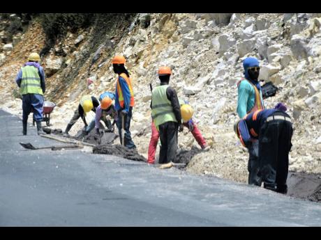 Workers from CHEC carry out road expansion work on the Ferris to Mackfield main road.