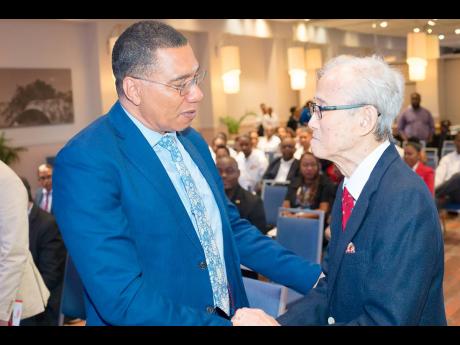 Credit: Contributed Prime Minister Andrew Holness (left) greets Karl Hendrickson.
