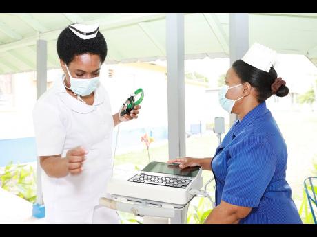 The National Chest Hospital has been named as one of the beneficiaries for the 2024 Sagicor Sigma ‘Honour Run’ slated for Sunday, February 18, in New Kingston. From left: National Chest Hospital staff nurses Tennesh Dillion and Andrene Morrison examine