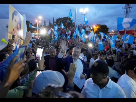 Guatemala’s President-elect Bernardo Arévalo greets the crowd as he arrives at a march by indigenous people to demand the resignation of Attorney General Consuelo Porras, outside the Supreme Court building in Guatemala City.