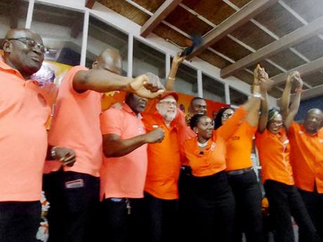 Credit: Bryan Miller Leader of the Opposition Mark Golding (fourth left) celebrates on stage with his Hanover team of representatives for the upcoming elections. The team was presented to the public at a meeting held in the auditorium of the Rusea’s High School in Lucea on S