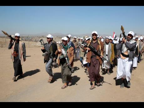 Houthi fighters stage a rally against the US government designating Houthis as a terror group and against the US-led sustained airstrikes on Yemen, near Sanaa, Yemen.