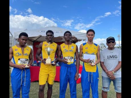From left: Members of the St Elizabeth Technical 4x800-metre relay team, Odaine Thompson, Rashid Bowen Green, Barrain Smith, and Joqueem Miller, pose with Michael Ollivierre, co founder of the STETHS Invitational track meet after receiving first-place priz