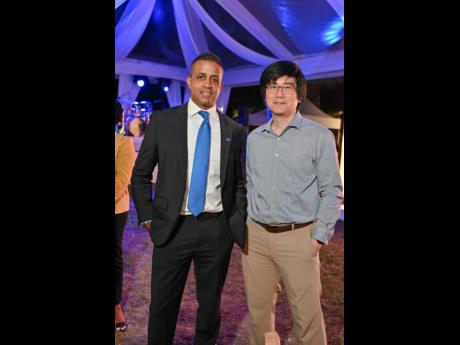 Jason Saunders (left), head of corporate banking, and Damian Chin, director of finance, Sandals, paused their confab for a quick photo. 