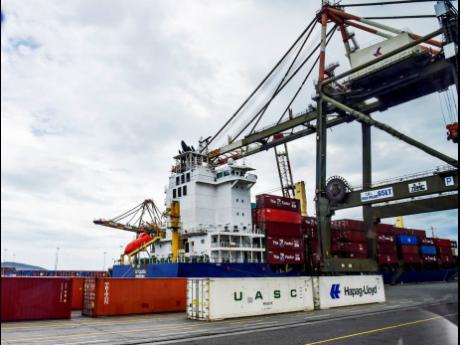 Cargo being unloaded from a ship at the Kingston Freeport.