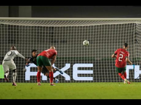 Morocco’s Achraf Hakimi (right) fails to score from a penalty kick during an Africa Cup of Nations round of 16 football match against South Africa at the Laurent Pokou stadium in San Pédro, Ivory Coast yesterday.