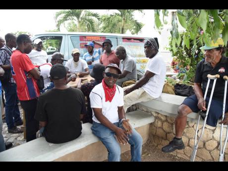 A small crowd gathered to watch a game of domino inside the St William Grant Park during the ‘Know Your Numbers’ screening campaign.