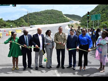 Credit: Rudolph Brown/Photographer Prime Minister Andrew Holness (fifth left) and other officials cut the ribbon to officially open the Harbour View to Yallahs Bridge section of the Southern Coastal Highway Improvement Project on Tuesday. Joining in the occasion are (from left) St Thomas Ea
