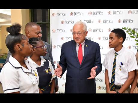 Credit: Contributed Minister of Justice Delroy Chuck (second right) speaking with students of Kingston High School during the 15th staging of the Restorative Justice Conference held on Wednesday at The Summit in Kingston. They are (from left) Ashanti Miller, K’Cian Gibson