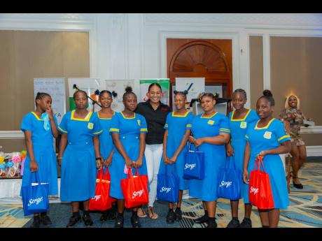 Camille Moore (centre), brand manager of Serge Dairies, is all smiles with the students of Cambridge High School.