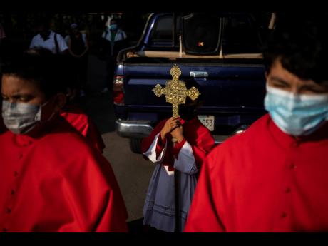 Catholics take part in a re-enactment of the Stations of the Cross during the Lenten season at the Metropolitan Cathedral in Managua.
