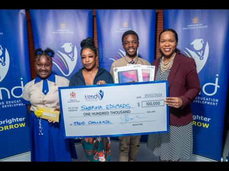 Dr Kasan Troupe, permanent secretary in the Ministry of Education and Youth, pauses for a photo op with the winners. From left: Leighanna Lowe, the third-place winner and first-form student of Holy Childhood High School; Patricia Burnett, the cousin of the