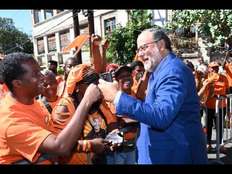 St Andrew Southern Member of Parliament and Opposition Leader Mark Golding greets People’s National Party supporters.