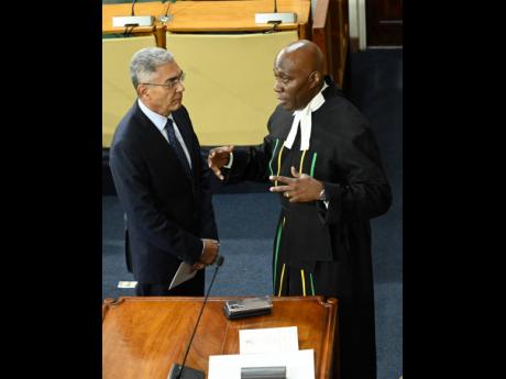 Credit: Rudolph Brown/Photographer Richard Byles (left), governor of the Bank of Jamaica, chats with Chief Justice Bryan Sykes on Thursday at Gordon House following the ceremonial opening of Parliament to kick off the new legislative year.