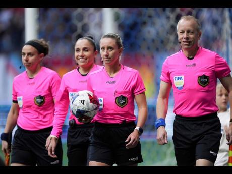 
Referee Tori Penso (second from right); fourth official Felisha Mariscal (second from left); and assistant referees Brooke Mayo (left), and Corey Rockwell (right), walk onto the field before the Vancouver Whitecaps and Colorado Rapids played in an MLS foo