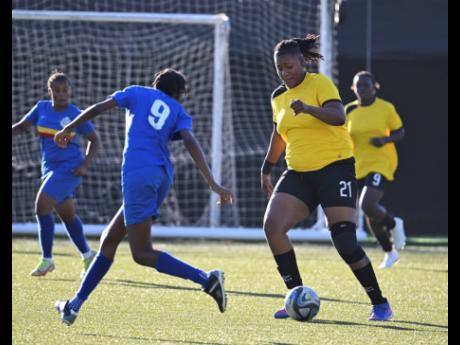 
Cavalier’s Sashana Watson takes on Proven’s Keylee Edwards during the opening game of the Sherwin Williams Jamaica Women’s Premier League at the UWI-JFF Captain Horace Burrell Centre of Excellence yesterday.