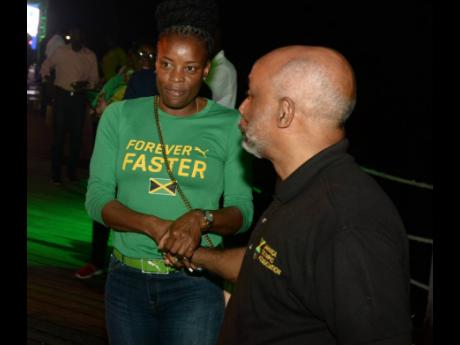 Jamaica Olympic Association President Christopher Samuda (right) and Juliet Campbell, Manager Sports Marketing Central at Puma.