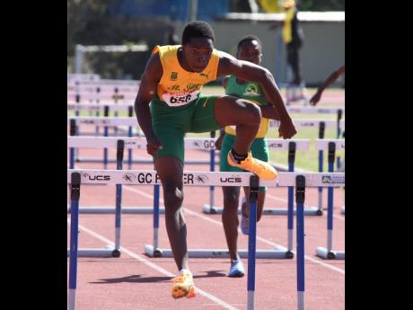 St Jago High School’s Marquies Page runs away with the Class 3 Boys’ 100-metre Hurdles in a new championship record of 13.19 seconds during the Central Athletics Championships at G.C. Foster College yesterday.
