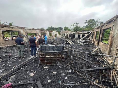 This photo provided by Guyana’s Department of Public Information shows the charred remains of a dormitory at a high school for Indigenous girls after an overnight fire in Mahdia, Guyana, on May 22, 2023. 