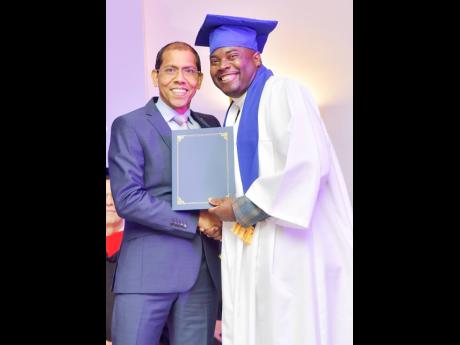 Shawn DaCosta (left), Chief Operating Officer at Sandals Resorts, presents Shawn Thomas, assistant food and beverage manager at Beaches Ocho Rios with his diploma.