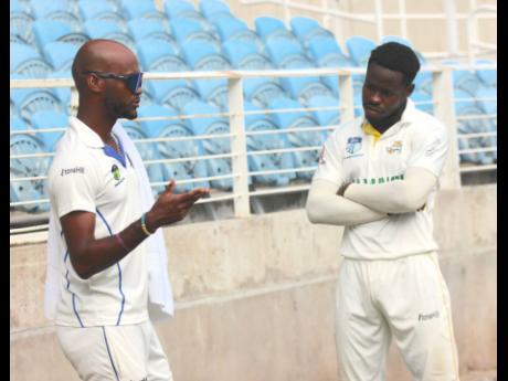 West Indies and Barbados Pride captain Kraigg Brathwaite (left) has a chat with Jamaica Scorpions batsman Kirk McKenzie following their West Indies Championship match at Sabina Park last Saturday.