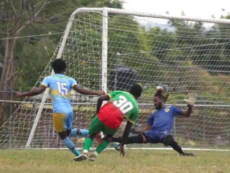 Credit: Lennox Aldred Andre Fletcher (left) scores the opening goal for Waterhouse past Humble Lion’s goalkeeper Shamal Briscoe during their Jamaica Premier League encounter at Effortville Community Centre yesterday. Looking on at centre is Humble Lion’s defender Afiba C