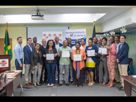 Participants displaying their certificates at the end of the workshop.