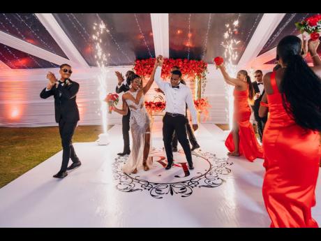 Credit: Joel Photography One change of outfit later, Jhaneil, in her Kayture Stylings dress, is twirled by her hubby Romaine as their wedding party cheers them on.