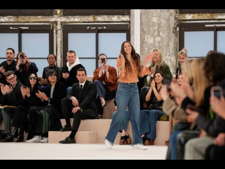 Designer Chemena Kamali accepts applause after the Chloe Fall/Winter 2024-2025 ready-to-wear collection presented on Thursday in Paris.