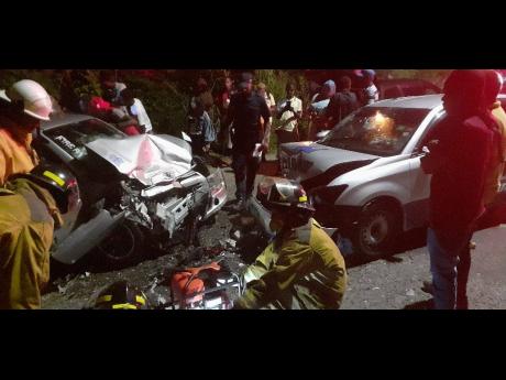 Emergency responders on the scene of an accident along the Temple Hall main road in St Andrew in the wee hours of Friday morning.