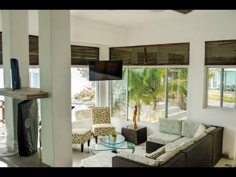 The glass-enclosed living area is at one with the awesome outdoors.