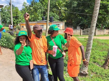 People’s National Party and Jamaica Labour Party supporters pose for a photo at Sawyers Primary and Infant School in Trelawny. 