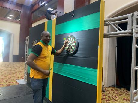 
Evon Faulkner, tournament director for the upcoming Caribbean Cup Darts Championship, and PDC qualifiers tests his skills at the tournaments’ venue, the Montego Bay Convention Centre, during a tour on February 24. 