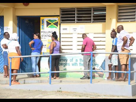People waiting to cast their votes for local elections at Granville Primary and Infant School, St James. 