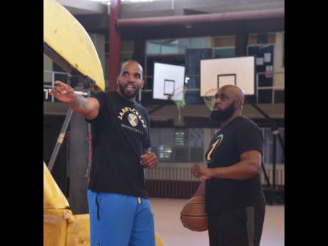 Jamaican basketballer Samardo Samuels (left) in a conversation with Wayne Dawkins, owner, P.H.A.S.E 1 Academy during a training session at Montego Bay Community College on Saturday, February 24, 2024